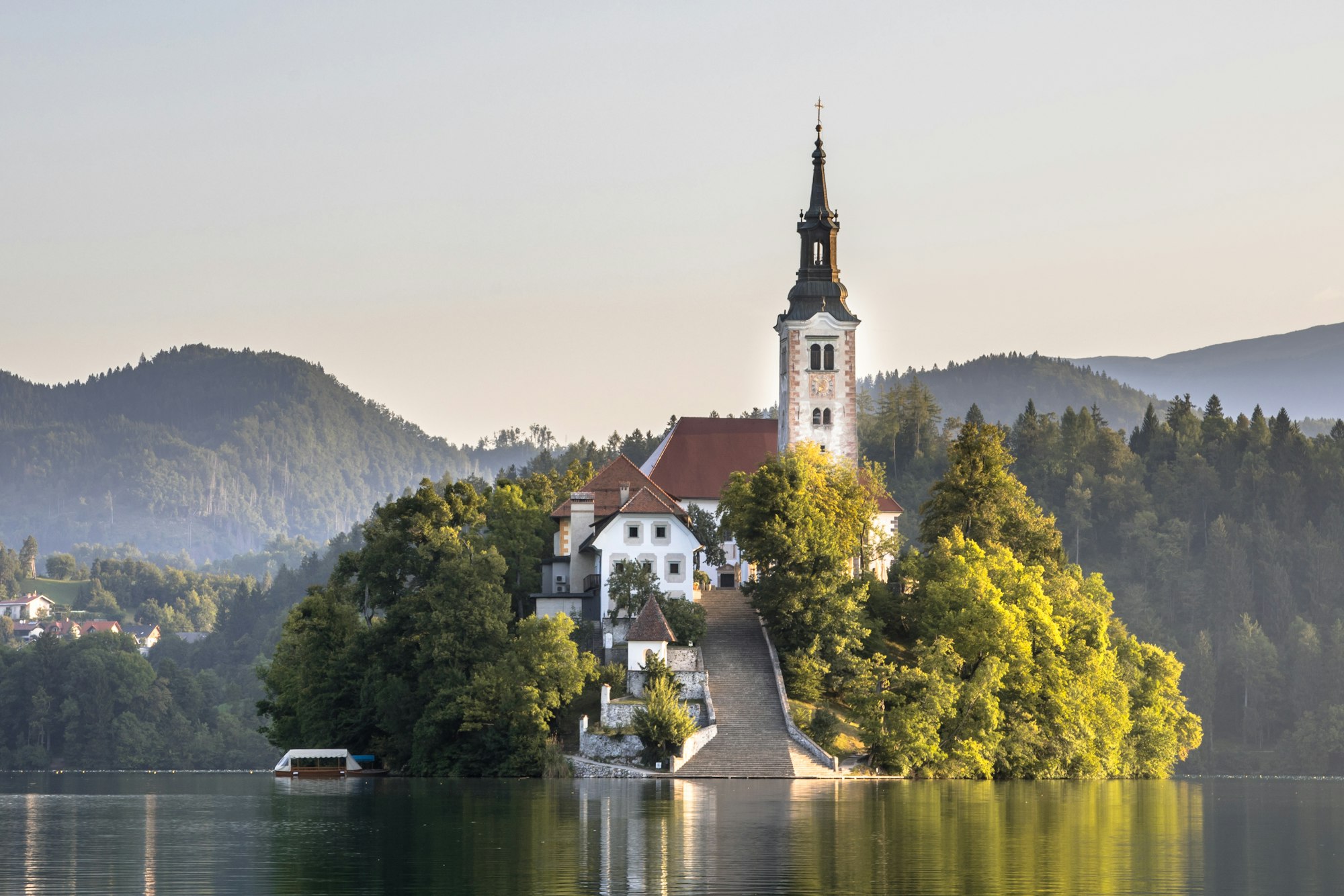 Island with church in lake Bled in hazy morning light