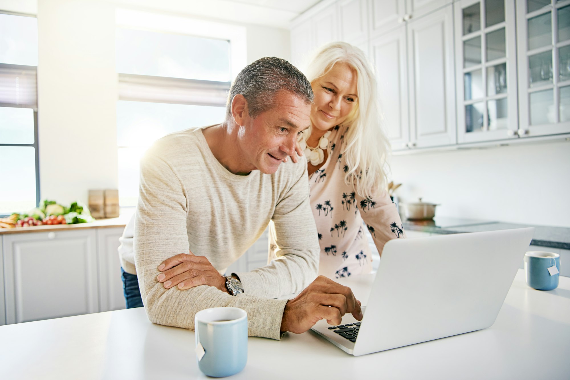 Elderly retired couple reading their social media