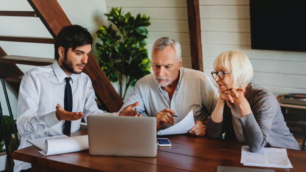 Male business agent planning with retired couple their investments